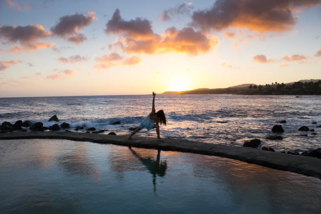 grounded morning routine woman doing yoga on beach
